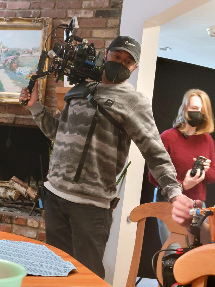 Gimbal operator moving through a living room set