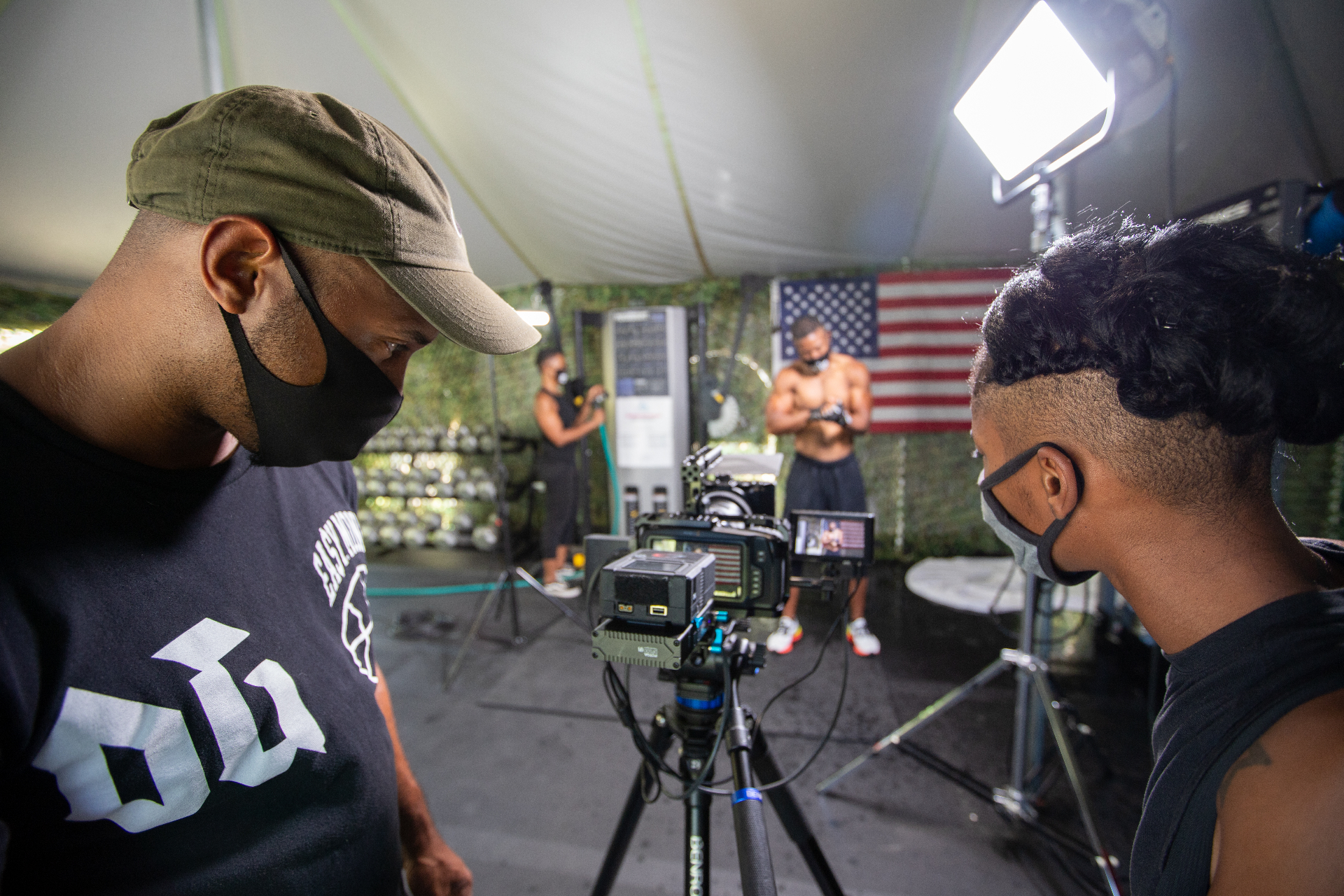 Directing an athlete shoot under a shade tent with an American flag