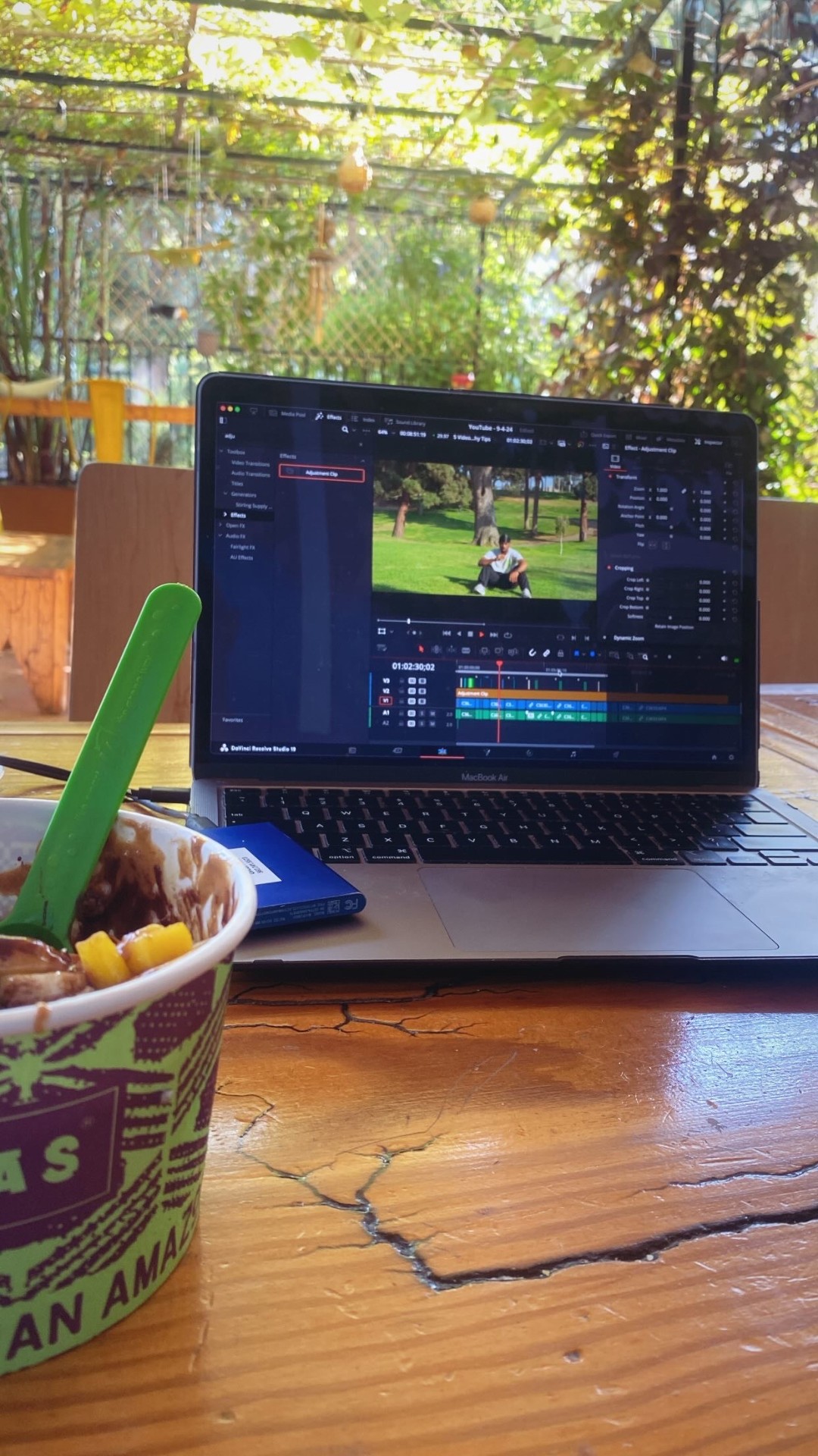 Editing in DaVinci Resolve outdoors at a cafe
